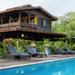 Luxury accommodations feature a calm pool on this yoga retreat in Panama with The Travel Yogi