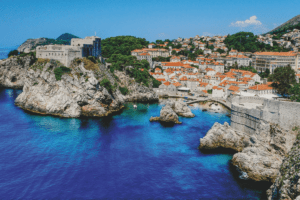 The coast of Dubrovnik, Croatia with a view of many houses with orange roofs.