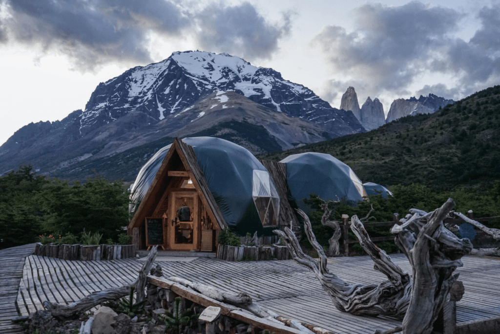 Brown wooden house near mountain. Explore the best sounds to wake you up with the Travel Yogi.