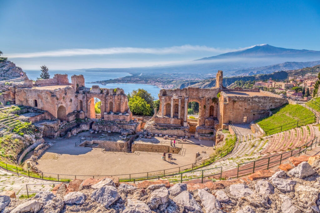 View of Teatro Greco in Taormina, Sicily. Find the best places to visit in Europe with the Travel Yogi.