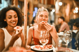 Two women eat bruschetta with wine to beat the post-vacation blues. Photo: Adrienn