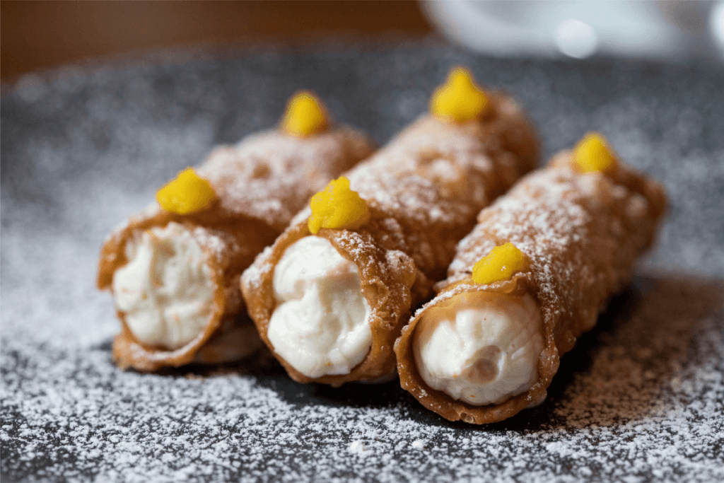 A crispy shell filled with sweet ricotta cream. Try the best food in Sicily with The Travel Yogi.