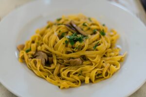 Delicious homemade traditional Italian pasta with porcini mushrooms by Gabriella Clare Marino via Unsplash.