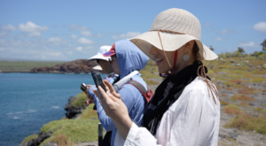 Traveler taking photo in the Galápagos via Dropbox.