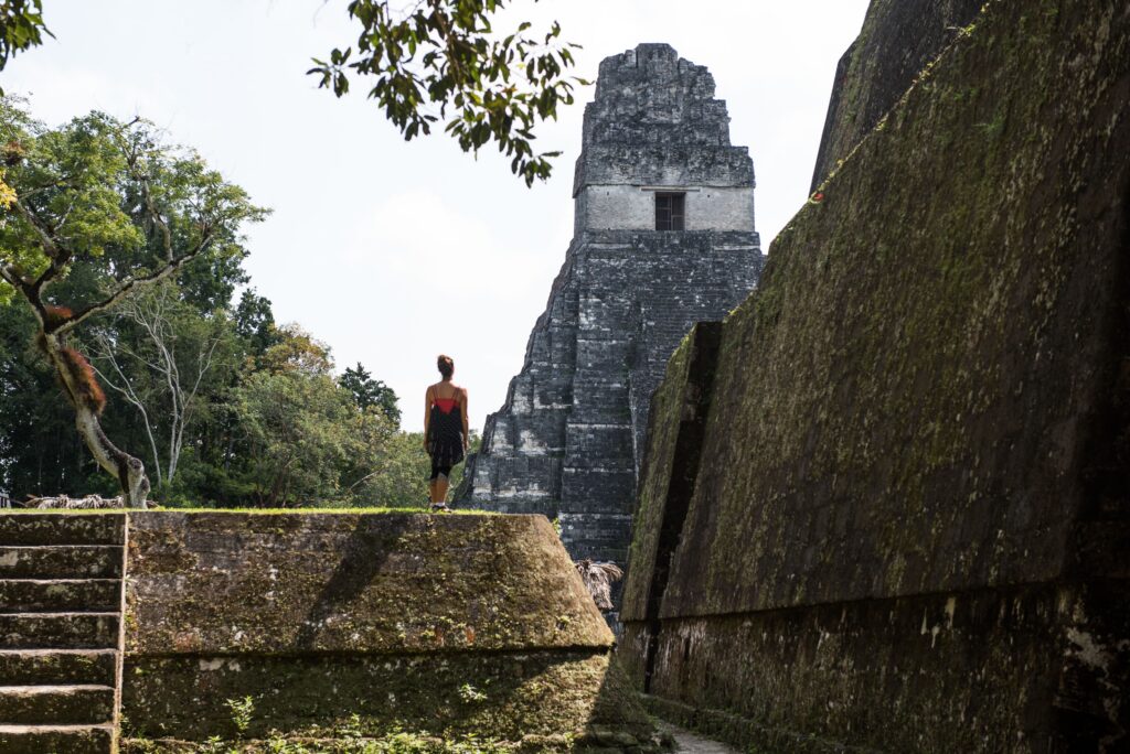 Person overlooking a temple at Tikal in Guatemala